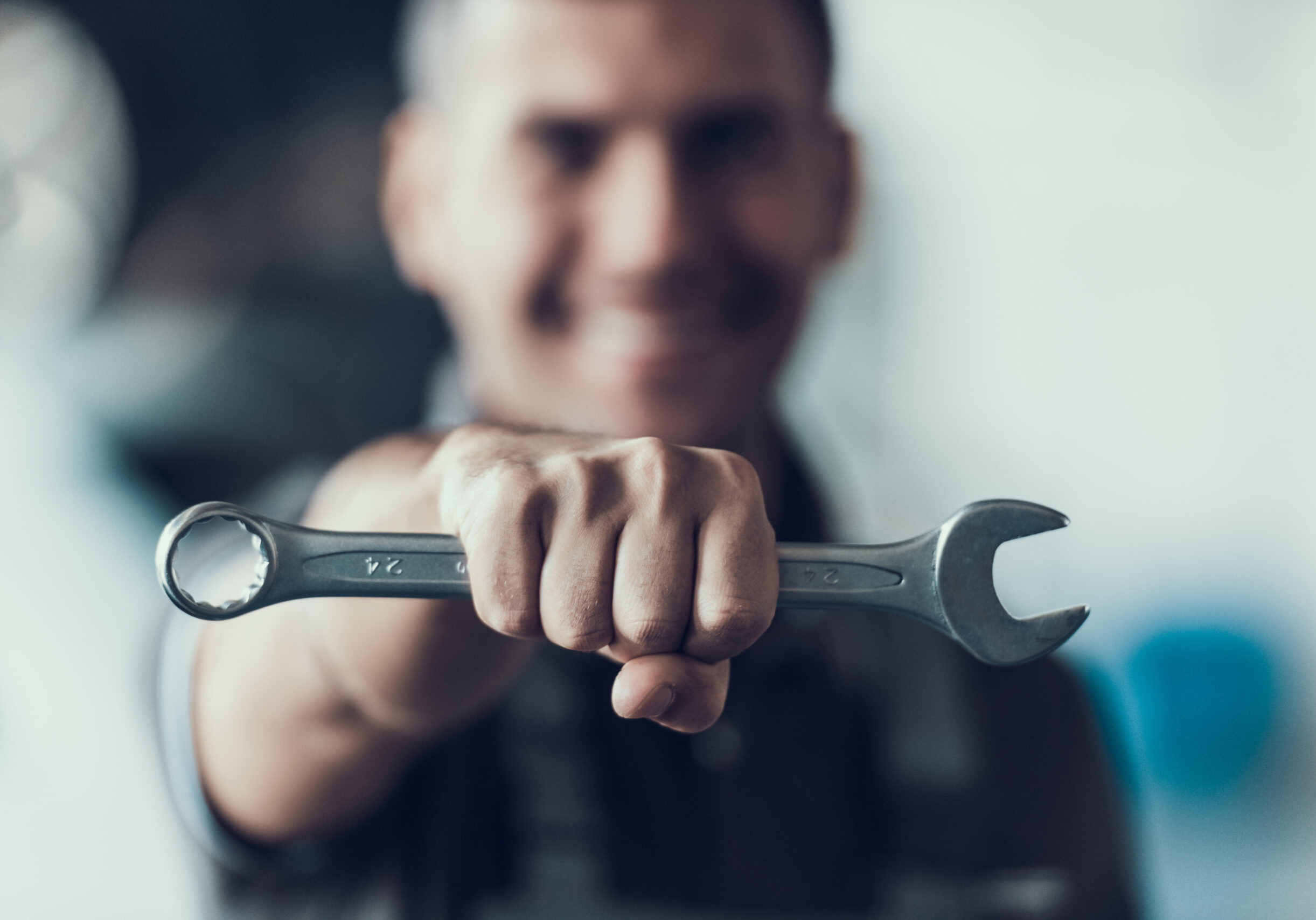 Auto,Mechanic,With,Tool,On,Blurred,Background.,Close-up,Of,Repairman